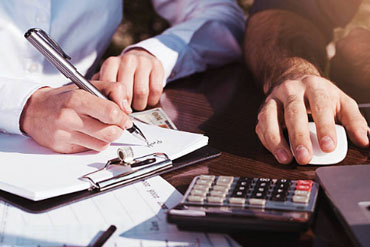 A financial paperwork and calculator image from the older BillSaver media library.
