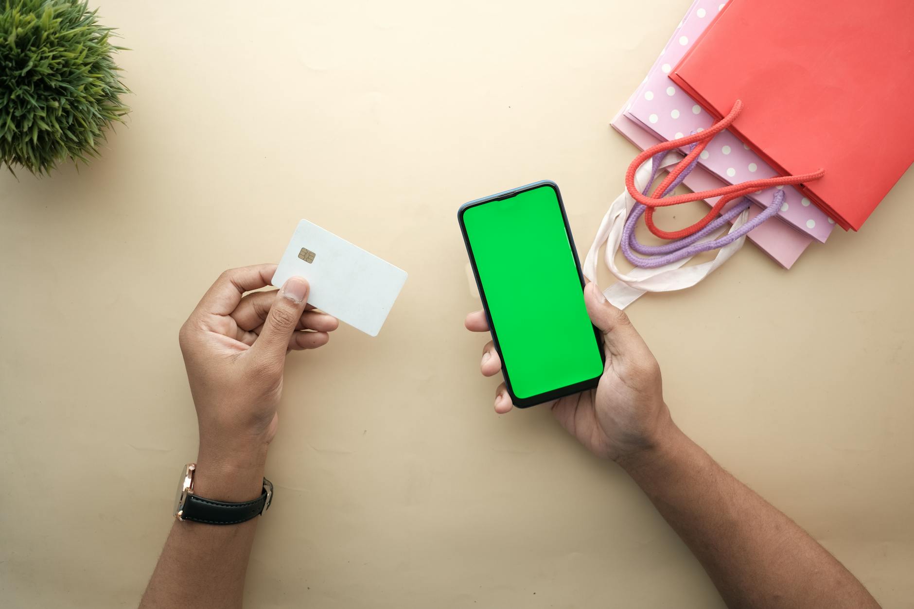 A shopping scene with a phone, card, and gift bags.