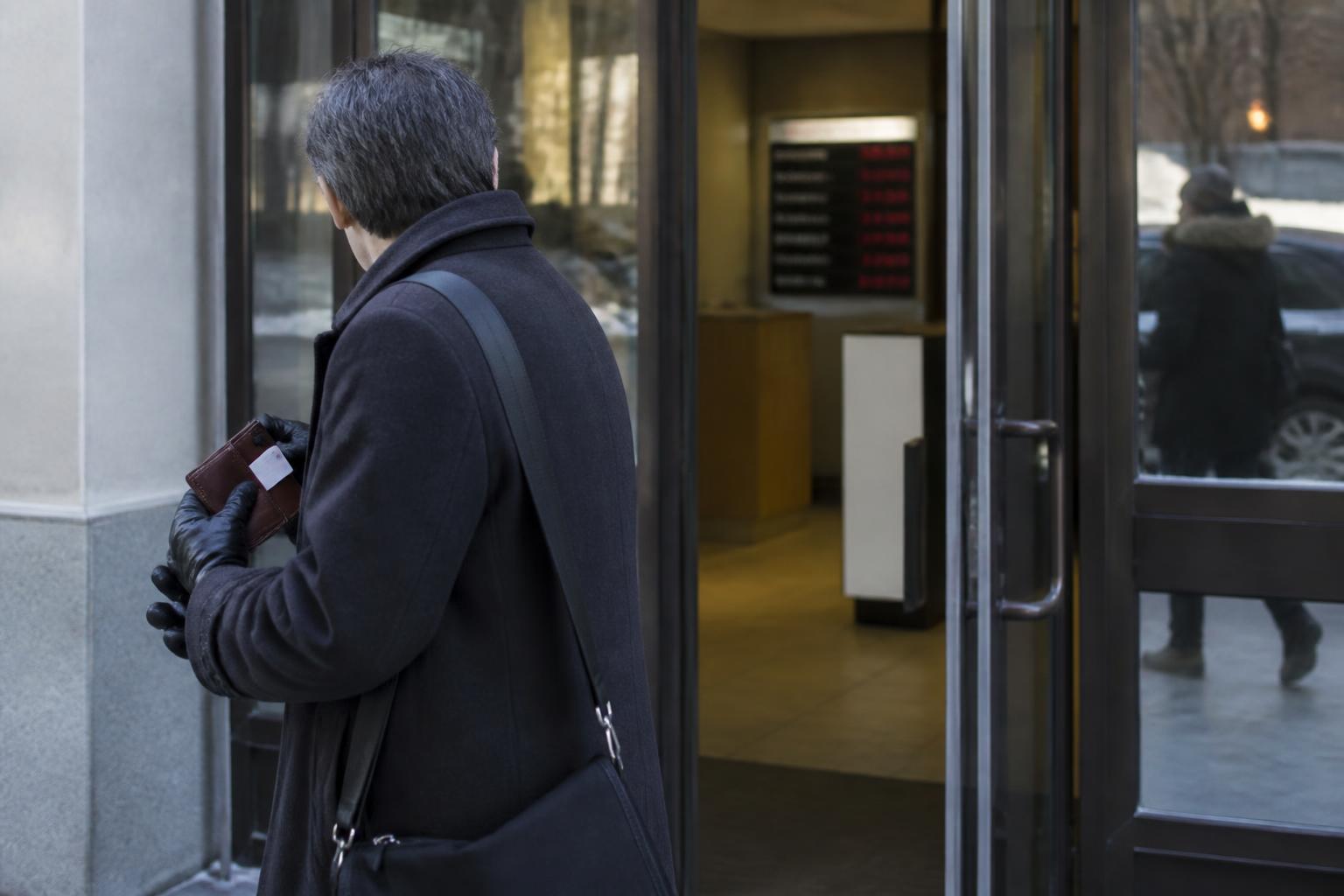 A borrower leaving a bank appointment during December rate-hike attention.