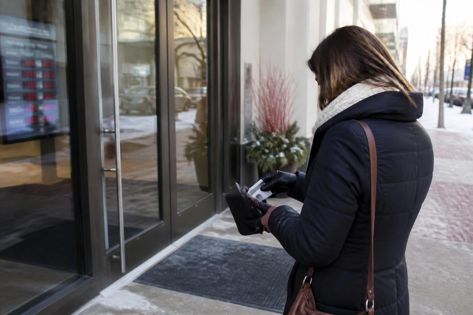 A borrower leaving a bank appointment during December rate-hike attention.