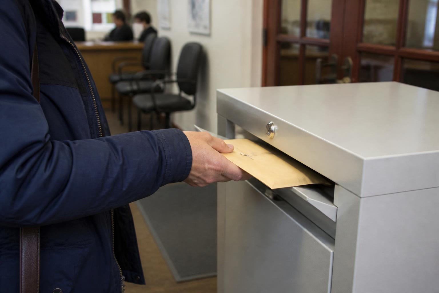 A taxpayer dropping sealed records at a tax-prep office.