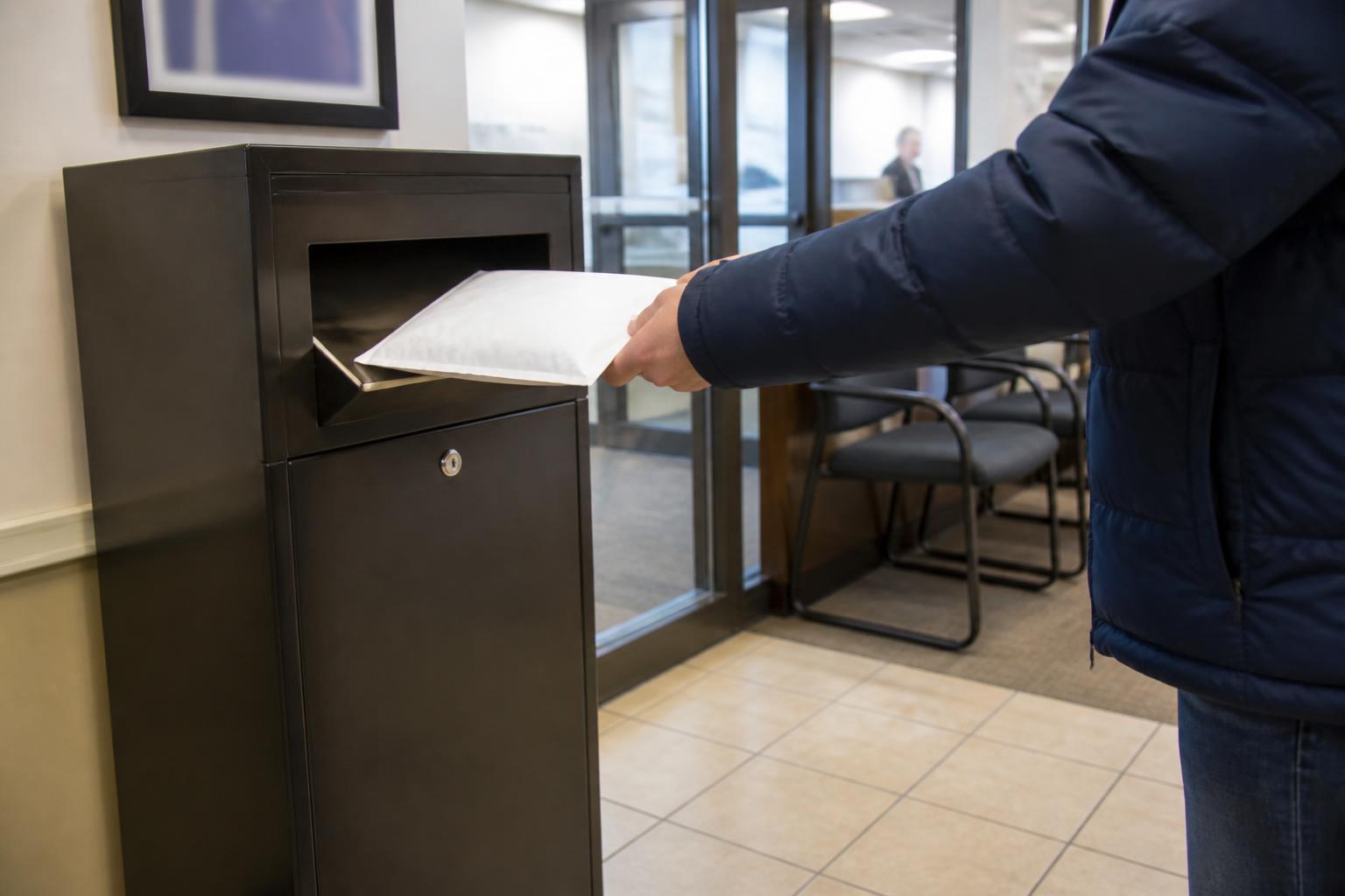 A taxpayer dropping sealed records at a tax-prep office.