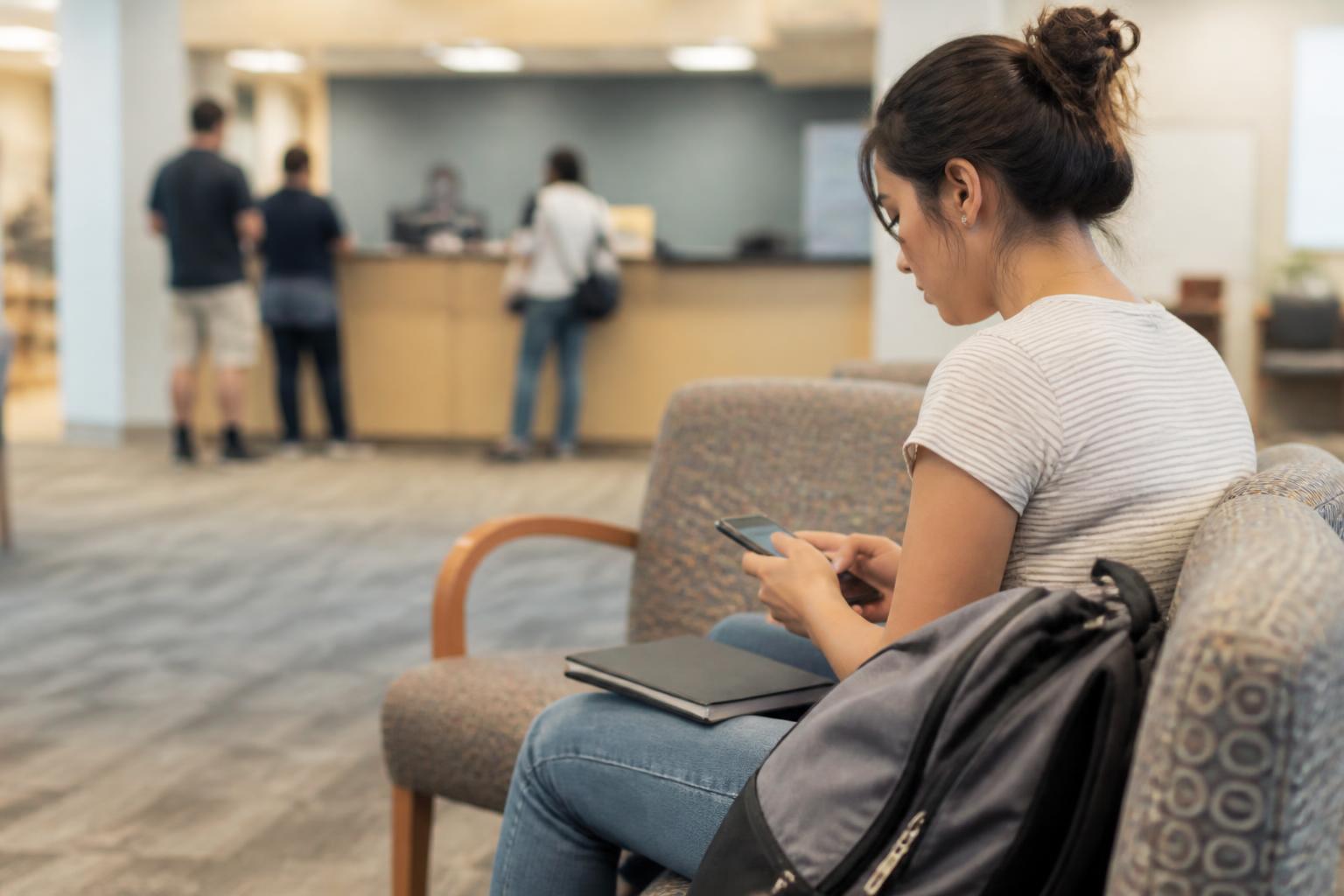 A borrower waiting in a campus financial-aid office.
