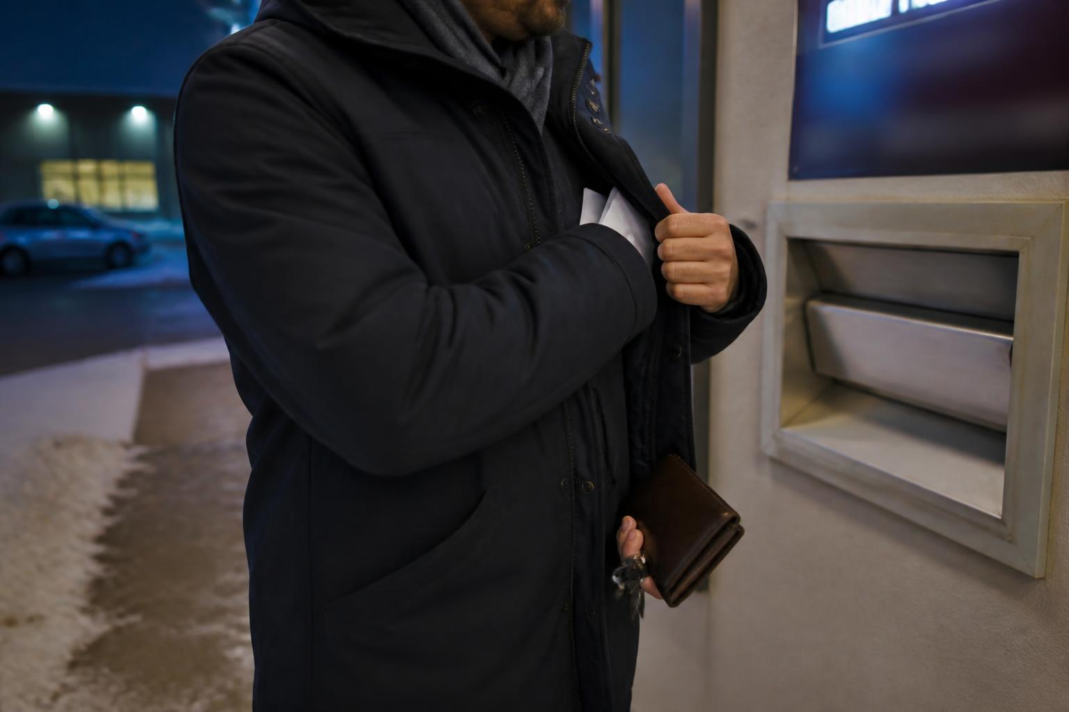 A borrower making a winter credit-card payoff errand after a Fed rate hold.