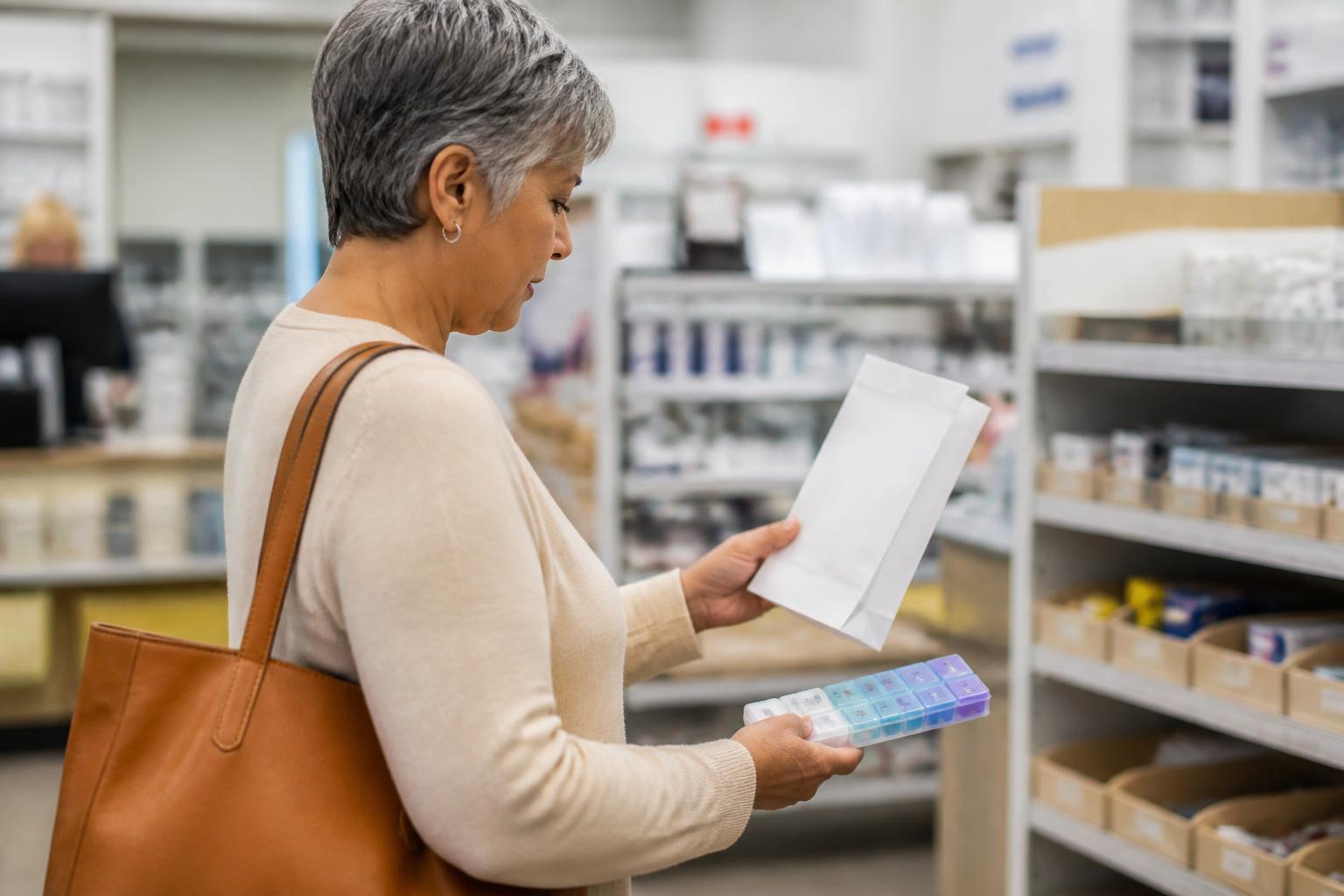 An older adult comparing pharmacy items during Part D planning.