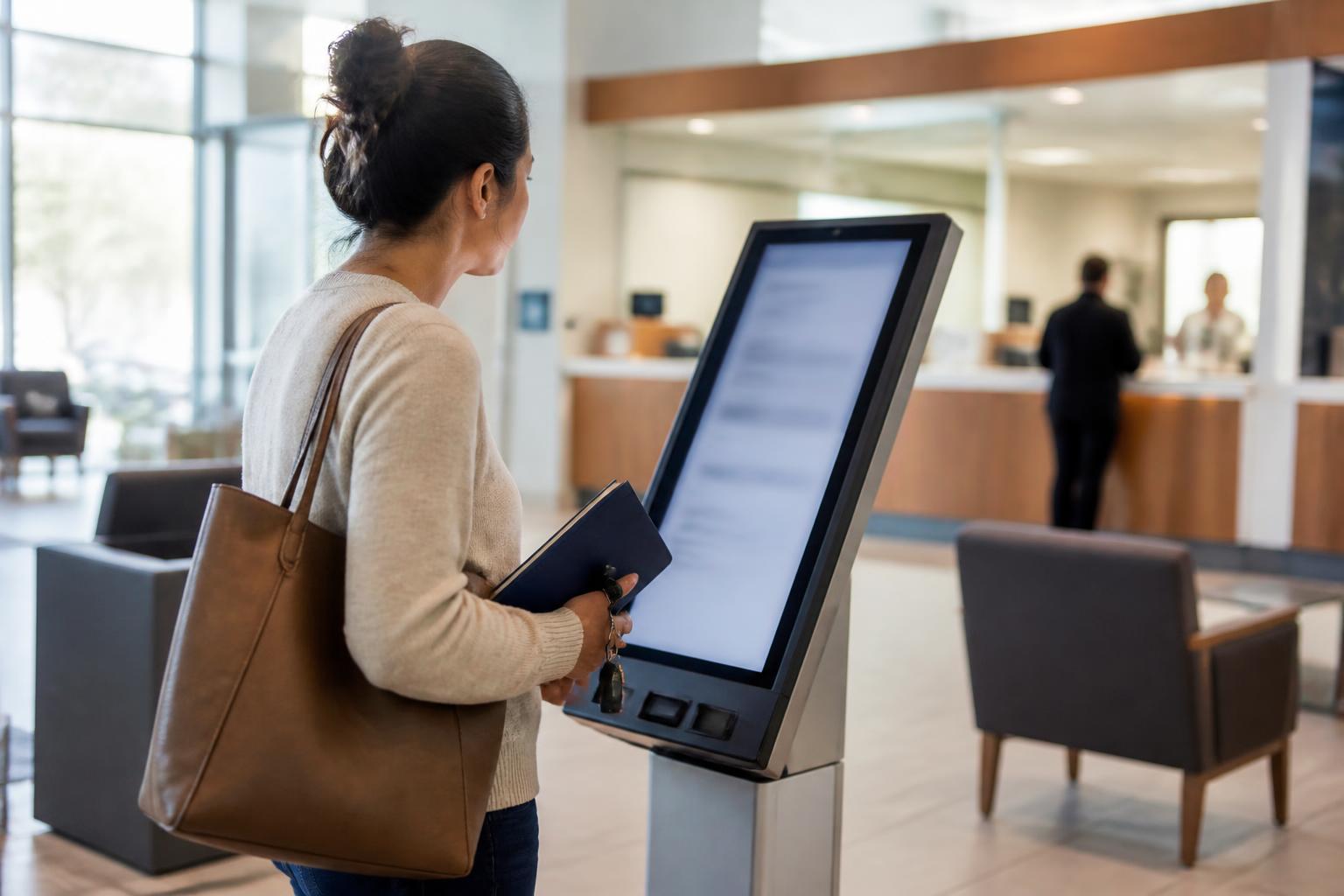 A saver comparing account options in a credit-union lobby.